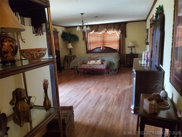 bedroom featuring crown molding and wood-type flooring