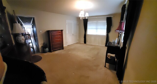 carpeted bedroom featuring an inviting chandelier and a closet