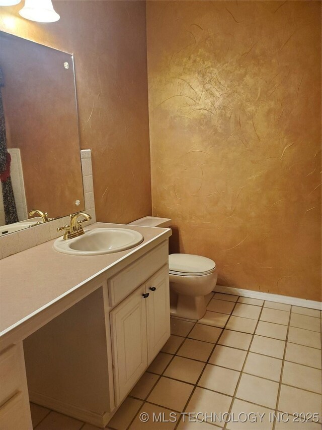 bathroom featuring vanity, tile patterned floors, and toilet