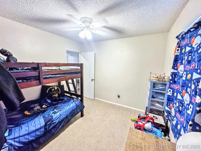 bedroom with ceiling fan, carpet, and a textured ceiling