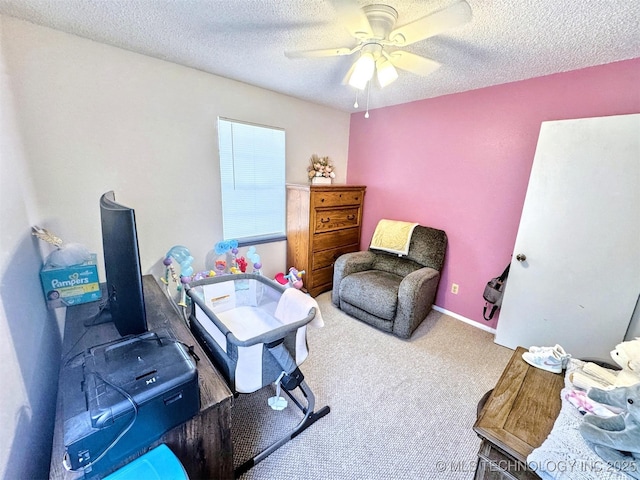 carpeted office space with ceiling fan and a textured ceiling