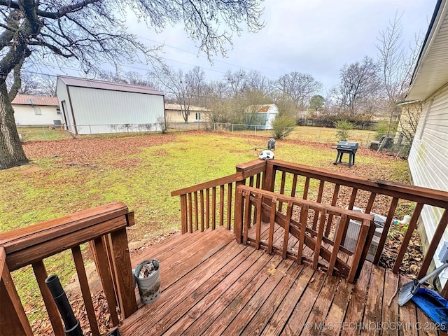 wooden deck with a yard and grilling area