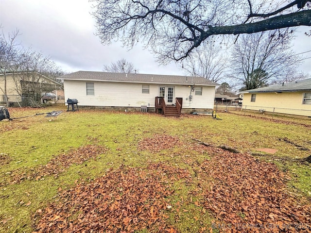 rear view of property featuring a yard