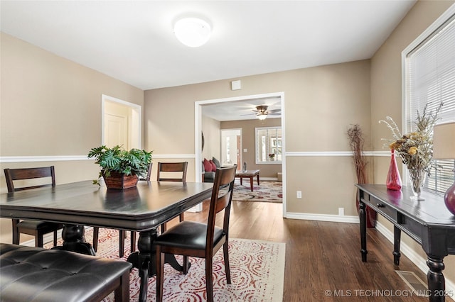 dining room with ceiling fan and dark hardwood / wood-style flooring