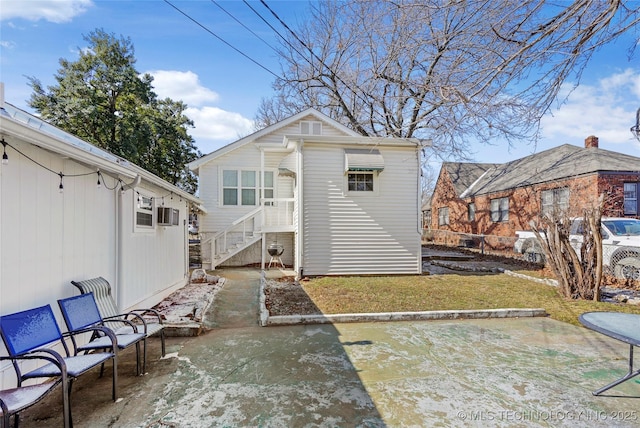 back of house with a patio and a yard