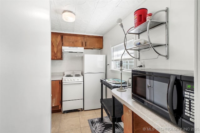 kitchen featuring white appliances, light tile patterned floors, and backsplash