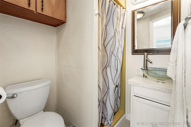 bathroom featuring curtained shower, vanity, and toilet