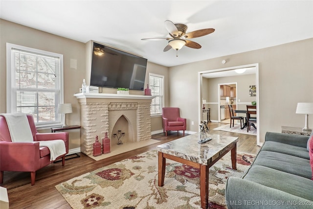 living room featuring hardwood / wood-style flooring and ceiling fan