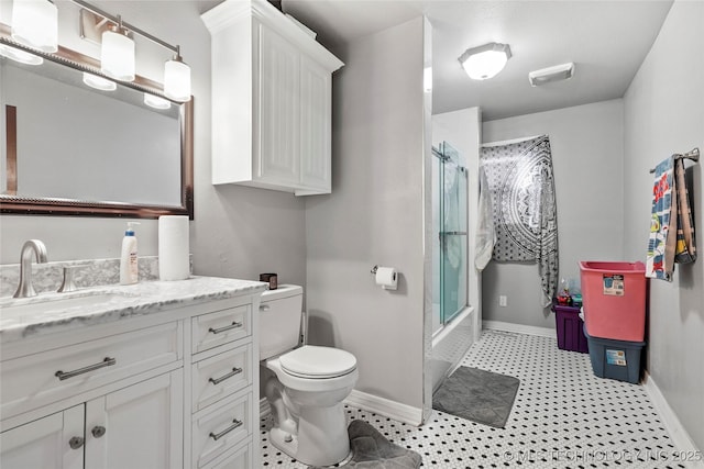 full bathroom featuring enclosed tub / shower combo, vanity, and toilet