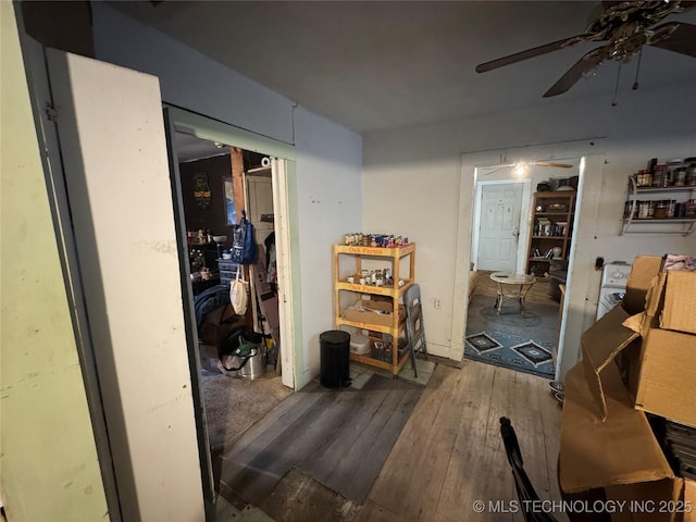 misc room with wood-type flooring and ceiling fan