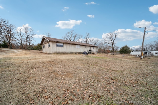 view of side of property with a lawn