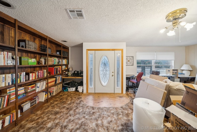 entrance foyer featuring a textured ceiling