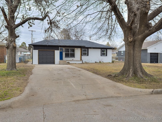 ranch-style home with a garage and a front lawn