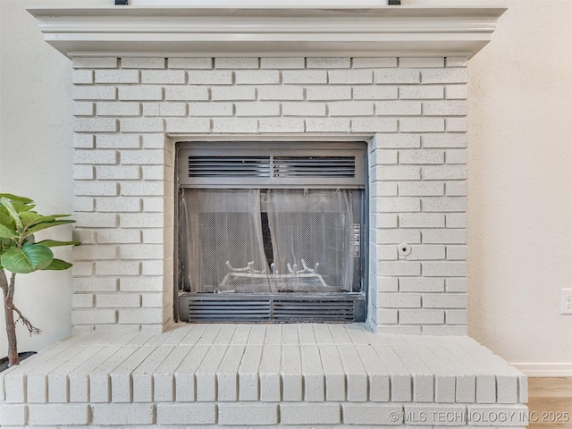 interior details with a brick fireplace