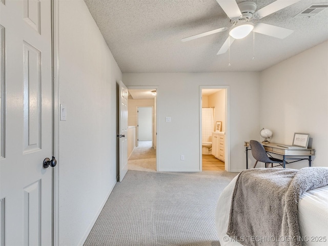 bedroom with light carpet, baseboards, visible vents, and a textured ceiling