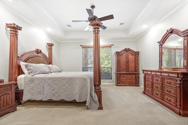 carpeted bedroom featuring a raised ceiling, ornamental molding, and ceiling fan