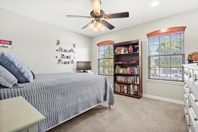 bedroom featuring carpet flooring, a ceiling fan, and baseboards