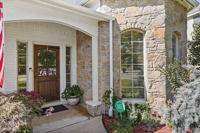 view of exterior entry featuring stone siding
