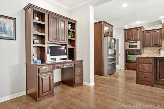 8117 E Freeport St, Broken Arrow, OK 74014 - home office featuring built in study area, dark wood-type flooring, ornamental molding, recessed lighting, and baseboards