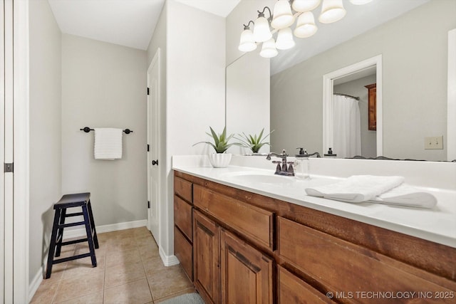 bathroom with tile patterned floors, vanity, and baseboards