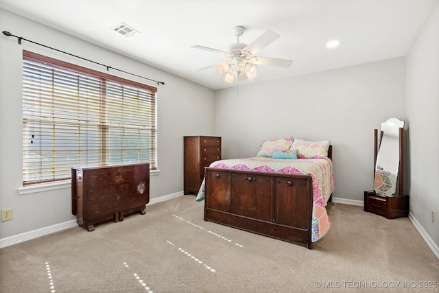 carpeted bedroom featuring visible vents, baseboards, and ceiling fan