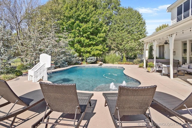 outdoor pool featuring an outdoor living space, a ceiling fan, and a patio area