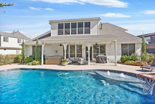 rear view of house with a patio area, an outdoor hangout area, a hot tub, and ceiling fan