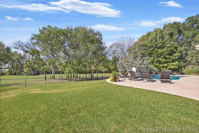 view of yard with a fenced in pool, a patio area, and a rural view