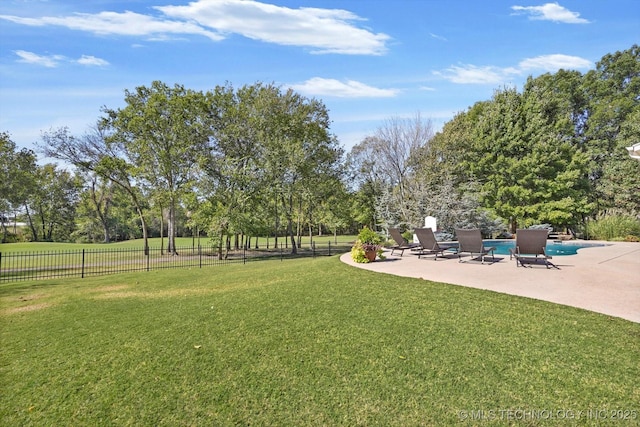 view of yard with a fenced in pool, a patio, and fence