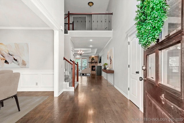 8117 E Freeport St, Broken Arrow, OK 74014 - entrance foyer featuring wood finished floors, stairs, a large fireplace, a high ceiling, and crown molding