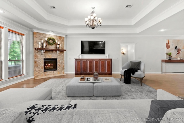 8117 E Freeport St, Broken Arrow, OK 74014 - living area featuring crown molding, a chandelier, wood finished floors, a tray ceiling, and a fireplace