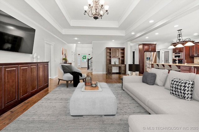 8117 E Freeport St, Broken Arrow, OK 74014 - living area featuring a chandelier, a tray ceiling, wood finished floors, recessed lighting, and crown molding