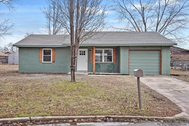 ranch-style house featuring a garage and a front yard