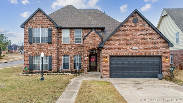 view of front of house with a garage and a front lawn