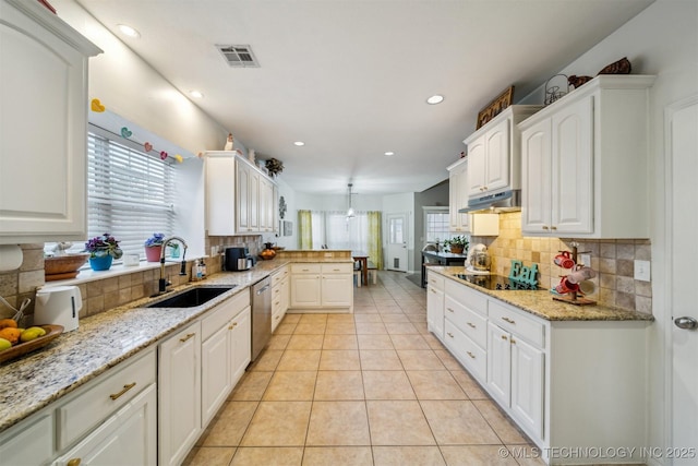 kitchen with white cabinetry, stainless steel dishwasher, sink, and light tile patterned floors