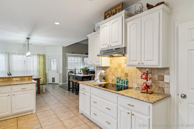 kitchen with pendant lighting, light tile patterned floors, white cabinetry, black electric stovetop, and decorative backsplash