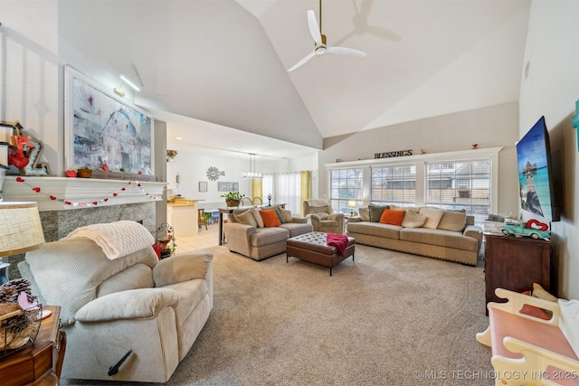 living room with high vaulted ceiling, light carpet, and ceiling fan