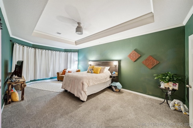 bedroom featuring crown molding, ceiling fan, a raised ceiling, and carpet floors