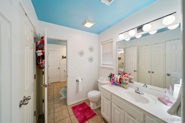 bathroom featuring vanity, toilet, and tile patterned flooring