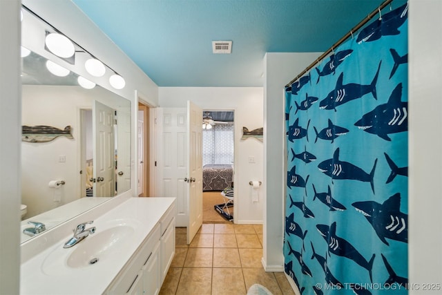 bathroom featuring a shower with shower curtain, vanity, and tile patterned flooring