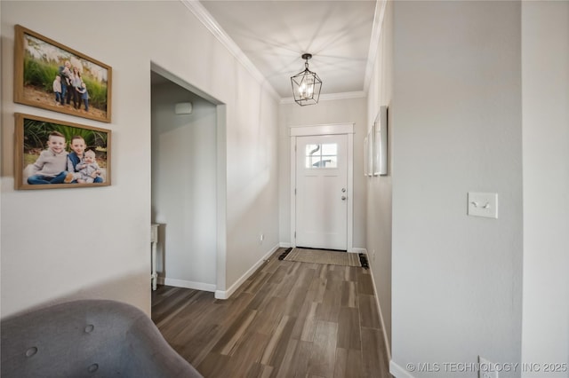 entrance foyer featuring dark hardwood / wood-style flooring, a notable chandelier, and crown molding