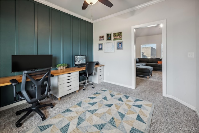 carpeted office with ornamental molding and ceiling fan