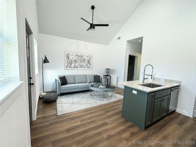 living room featuring dark hardwood / wood-style flooring, ceiling fan, sink, and high vaulted ceiling