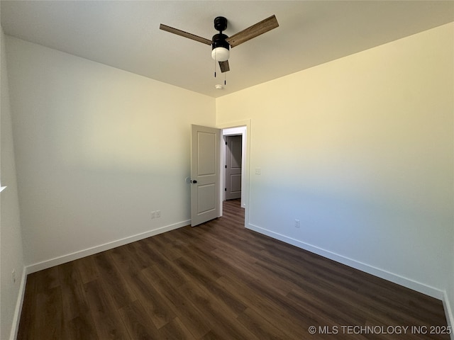 spare room featuring ceiling fan and dark hardwood / wood-style floors