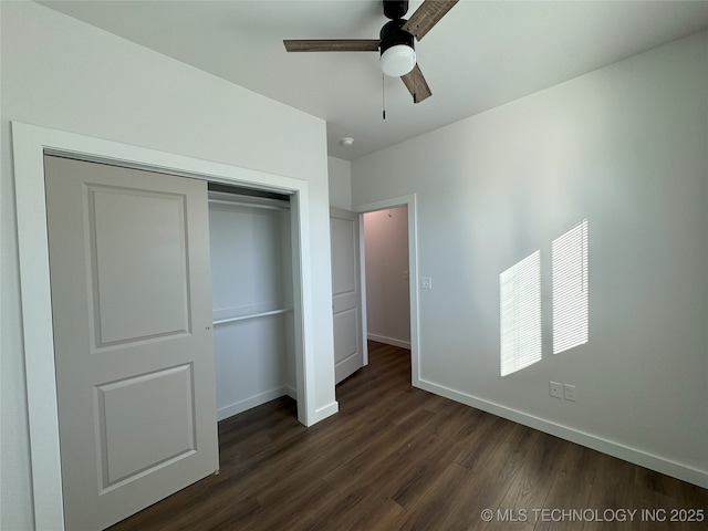 unfurnished bedroom featuring ceiling fan, a closet, and dark wood-type flooring