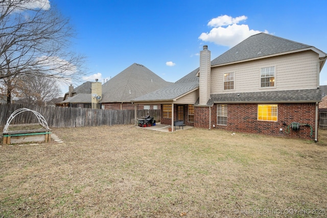 back of house featuring a yard and a patio area