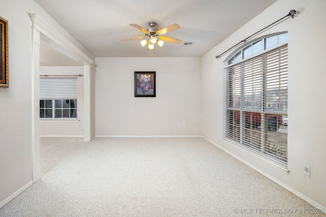 empty room with ceiling fan and carpet floors