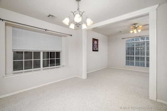 empty room featuring carpet flooring and ceiling fan with notable chandelier