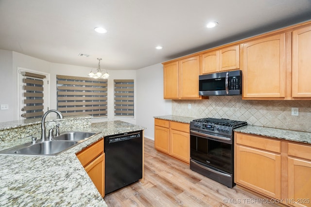 kitchen featuring sink, stainless steel gas stove, decorative light fixtures, light wood-type flooring, and dishwasher