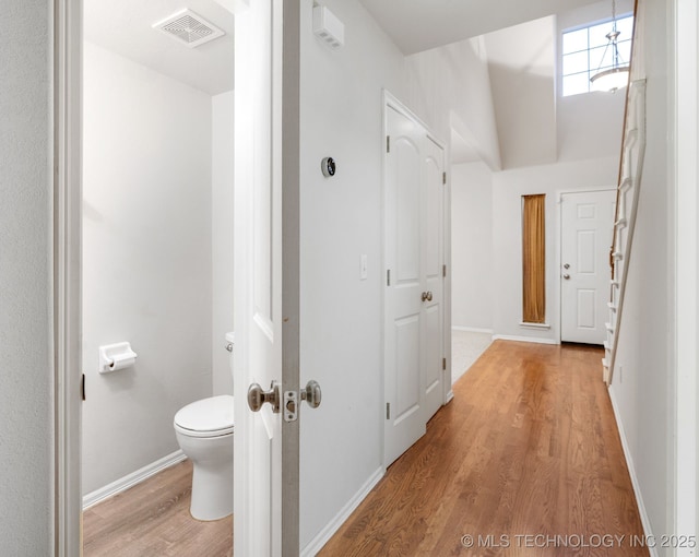 bathroom featuring hardwood / wood-style floors and toilet